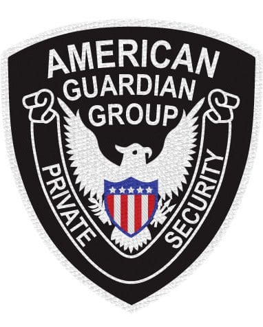 Embroidered patch American guardian group a private security with black background and whit e eagle in the middle. close-up of a patch a black and white patch with a white eagle and white stripes