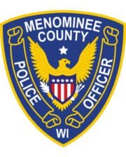 Patches and embroidery Menominee county police officer patch with a black and yellow patch with a white shield with a bird and text a blue and yellow shield with a white and red shield with a white and blue shield with a white and red striped eagle and a white star with a red stripe and a white star with a red