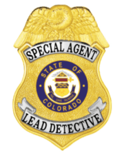 Detective gold badge with black text a close-up of a badge