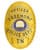 police badge officer Freemont Police department a gold badge with blue text