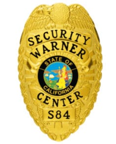 Warner center security gold badge with black text. Style #2-c13-2