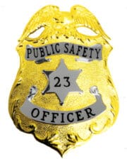 public Safety badge gold with black text a close-up of a police badge