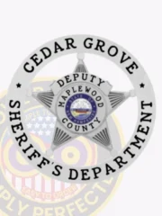 A custom metal badge in silver color with safety pin attachment, shaped like a star. The badge features the words "CEDAR GROVE" and "SHERIFF'S DEPARTMENT" in bold black text around the edge. In the center, it displays "DEPUTY" along with the emblem for "MAPLEWOOD COUNTY" and the state emblem of New Hampshire, providing an official and distinguished appearance for law enforcement personnel.