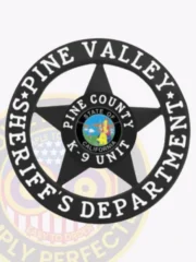 A custom metal badge in black color with safety pin attachment, shaped like a star. The badge features "PINE VALLEY" and "SHERIFF'S DEPARTMENT" in bold white lettering around the edge. In the center, it displays "K-9 UNIT" along with the emblem for Pine County, California, which includes colorful imagery. This badge conveys authority and professionalism for law enforcement personnel, particularly those working with K-9 units.