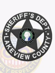 A custom metal badge in black color with safety pin attachment, shaped like a star. The badge prominently features "SHERIFF'S DEPT." and "LAKEVIEW COUNTY" in bold white lettering around the edge. In the center, it displays the state emblem of Washington, which includes a portrait of George Washington, emphasizing its formal and authoritative appearance for law enforcement personnel.