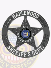 A custom metal badge in black color with safety pin attachment, shaped like a star. The badge prominently features "MAPLEWOOD" and "SHERIFF'S DEPT." in bold white lettering surrounding the outer edge. In the center, it includes the designation "K-9" along with the state emblem of New York, highlighting its official and professional design for law enforcement personnel who work with K-9 units.